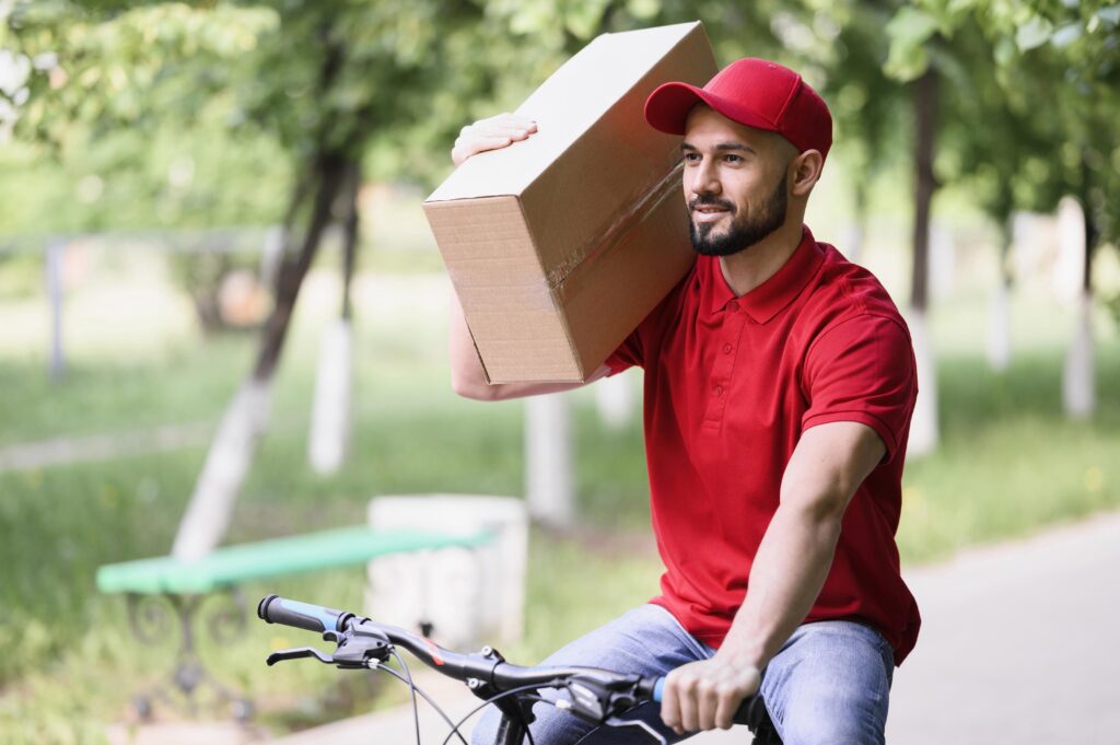 delivery man carrying box bike